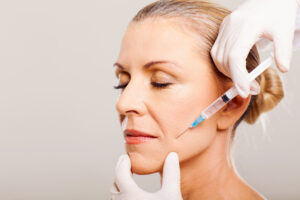 senior woman doing face lifting › Hellenic Laser Spa Close-up of a patient receiving Botox treatment, illustrating the process of smoothing wrinkles and fine lines