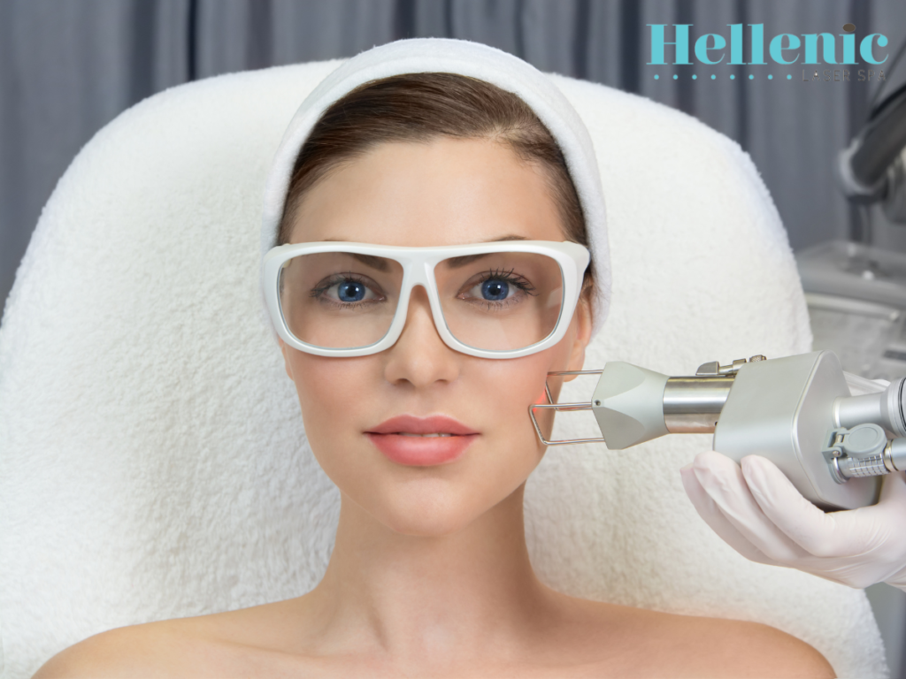A licensed aesthetic therapist performing a CO2 fractional laser rejuvenation procedure on a client in a professional beauty clinic treatment room.